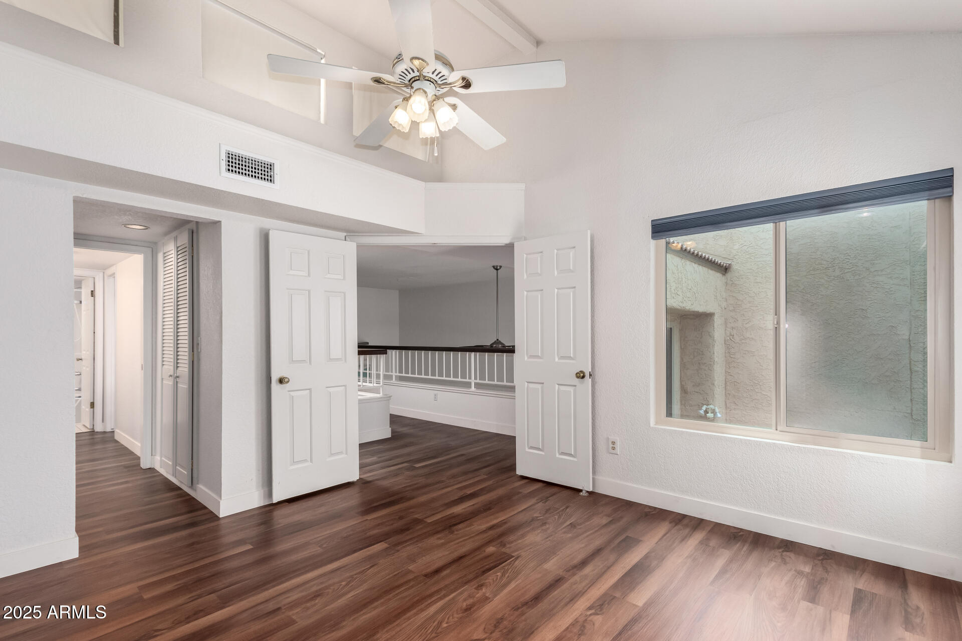 15439 North 1st Street Phoenix, AZ 85022 - Photo 22 of 26 a view of a livingroom with wooden floor and a kitchen space