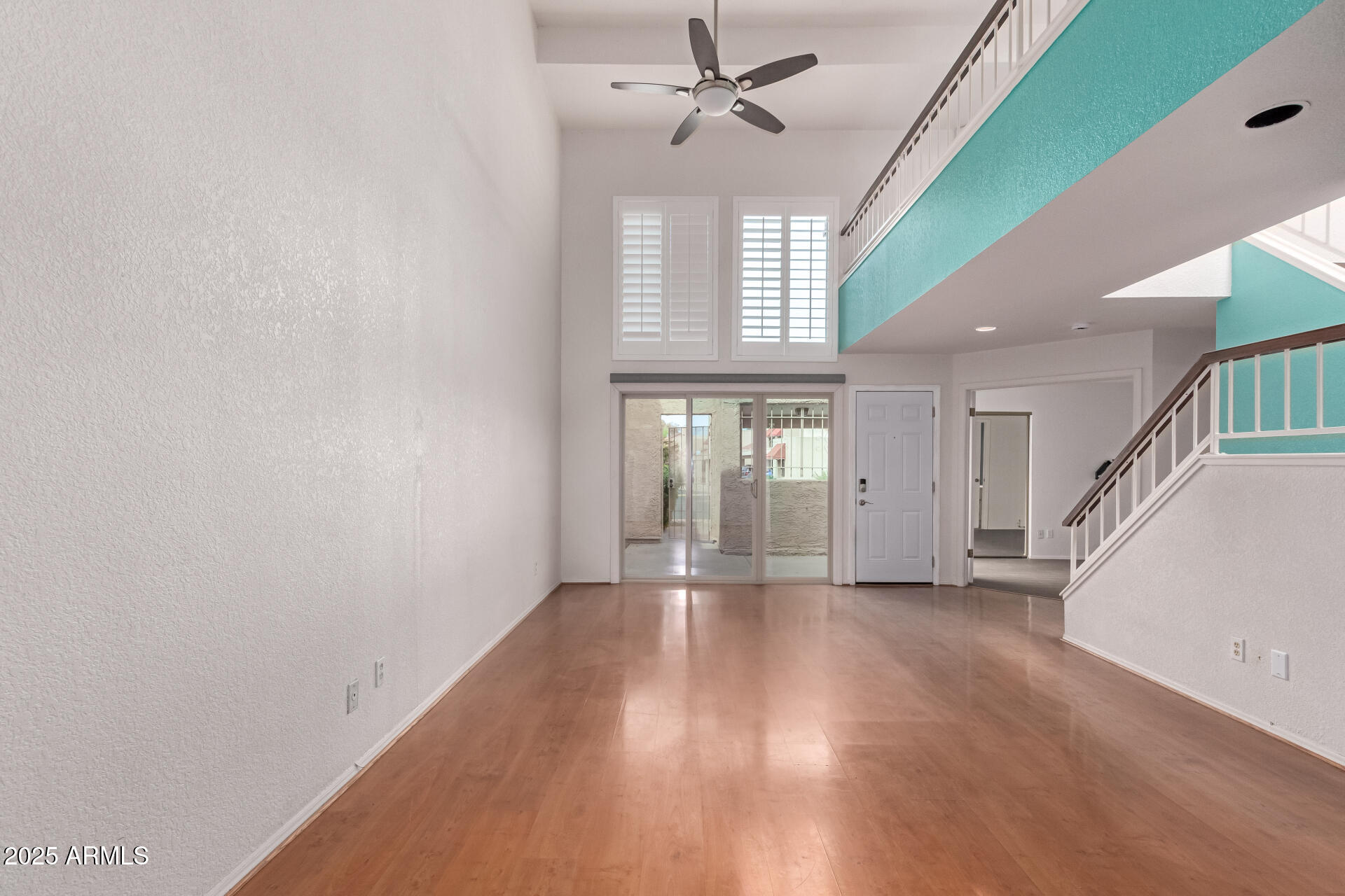 15439 North 1st Street Phoenix, AZ 85022 - Photo 7 of 26 an empty room with wooden floor and windows
