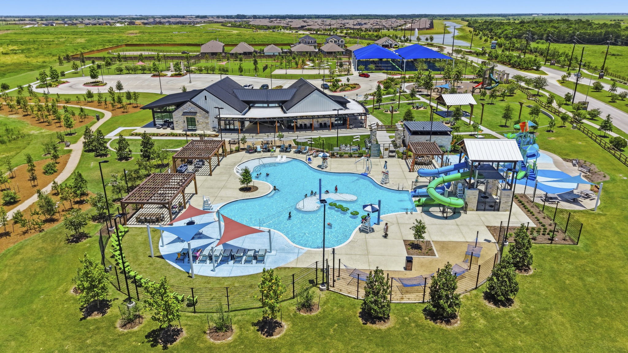 10934 Bonfire Trail Beasley, TX 77417 - Photo 32 of 32 Resort-style pool with water slides, cabanas, and family-friendly amenities creates the ultimate staycation experience.