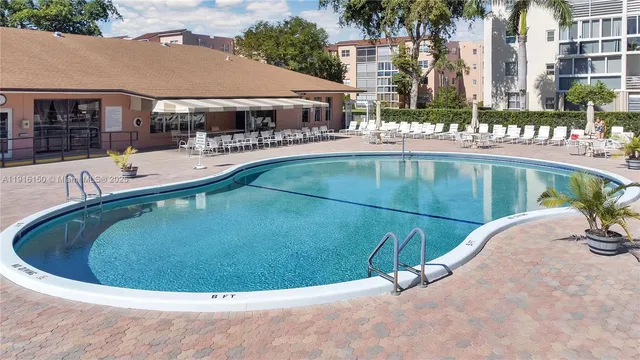 a view of a swimming pool with outdoor seating