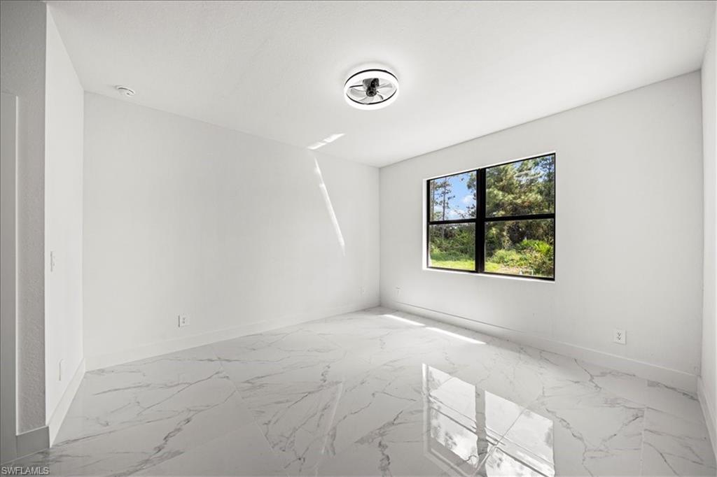 3315 67th Street West Lehigh Acres, FL 33971 - Photo 14 of 38 Unfurnished room with light marble finish floors