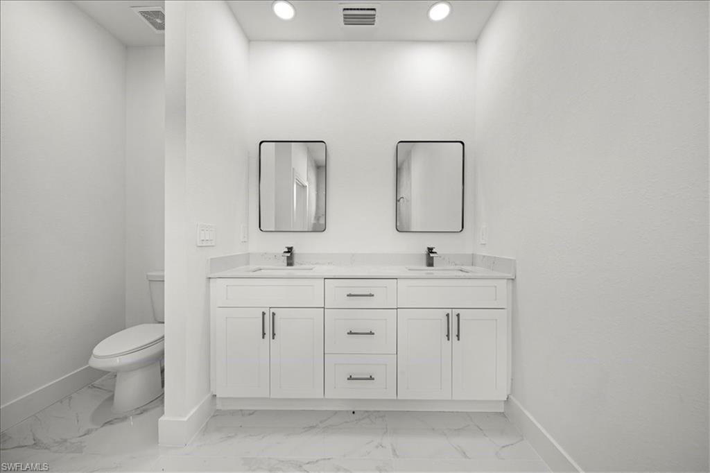 3315 67th Street West Lehigh Acres, FL 33971 - Photo 19 of 38 Full bathroom featuring light marble finish flooring and double vanity