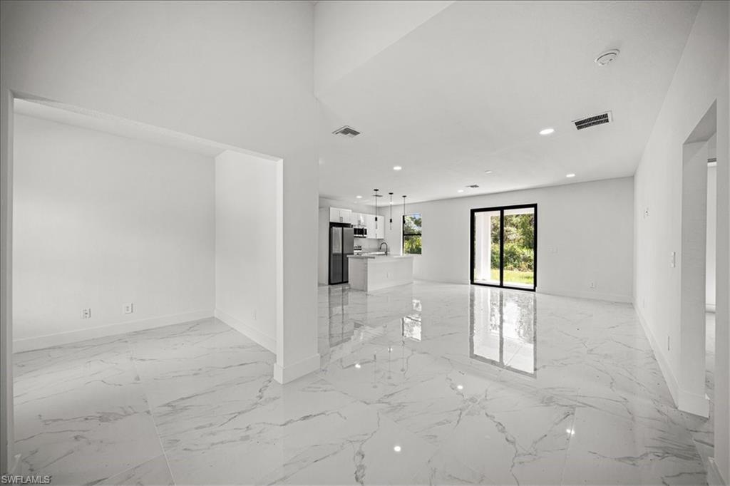 3315 67th Street West Lehigh Acres, FL 33971 - Photo 3 of 38 Empty room featuring light marble finish floors and recessed lighting