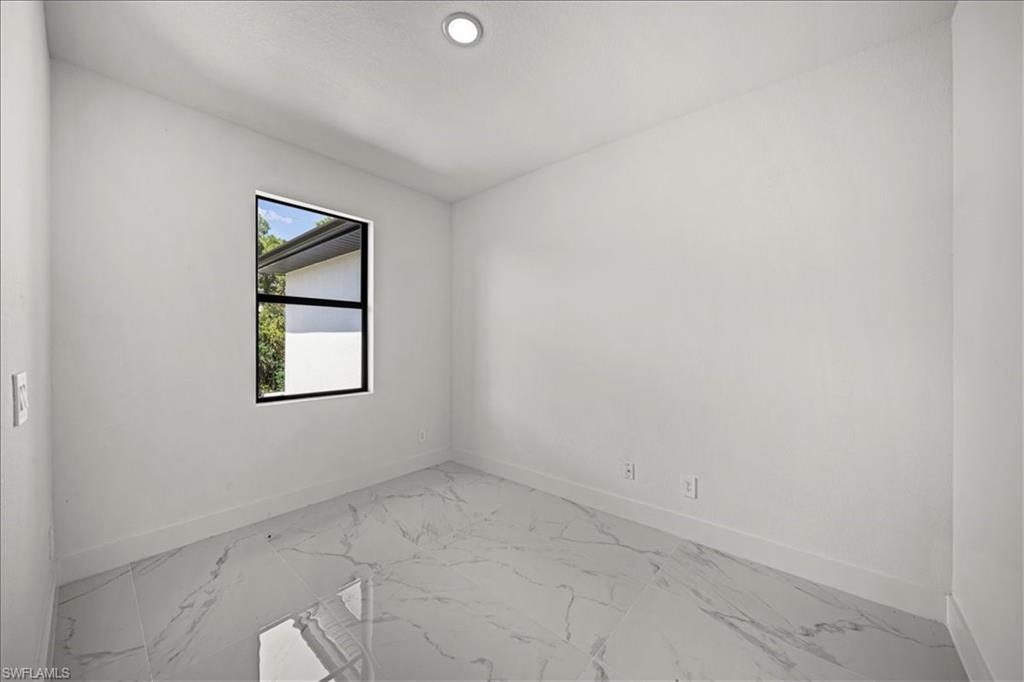 3315 67th Street West Lehigh Acres, FL 33971 - Photo 4 of 38 Unfurnished room with light marble finish flooring and recessed lighting