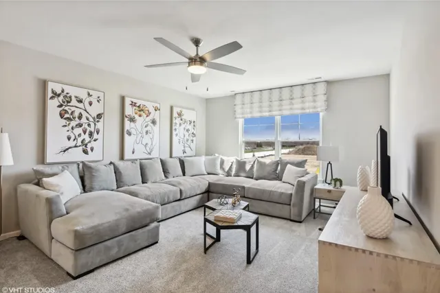 a living room with furniture a large window and a flat screen tv