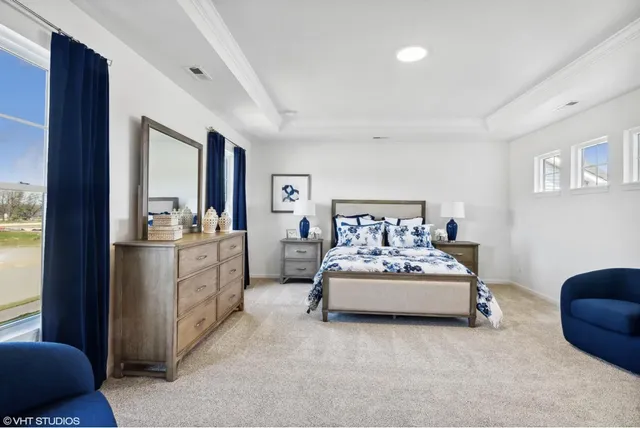 a spacious bedroom with a bed and a couch