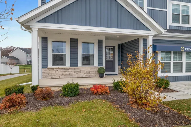 a front view of a house with garden