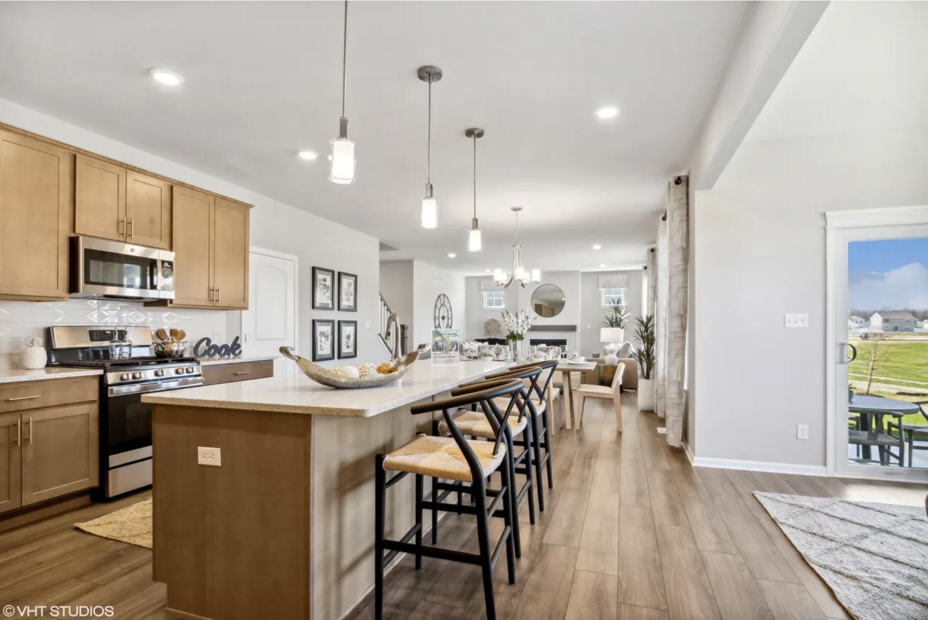 Undisclosed Address Winfield, IN 46307 - Photo 10 of 25 a kitchen with stainless steel appliances granite countertop a table chairs sink refrigerator and microwave