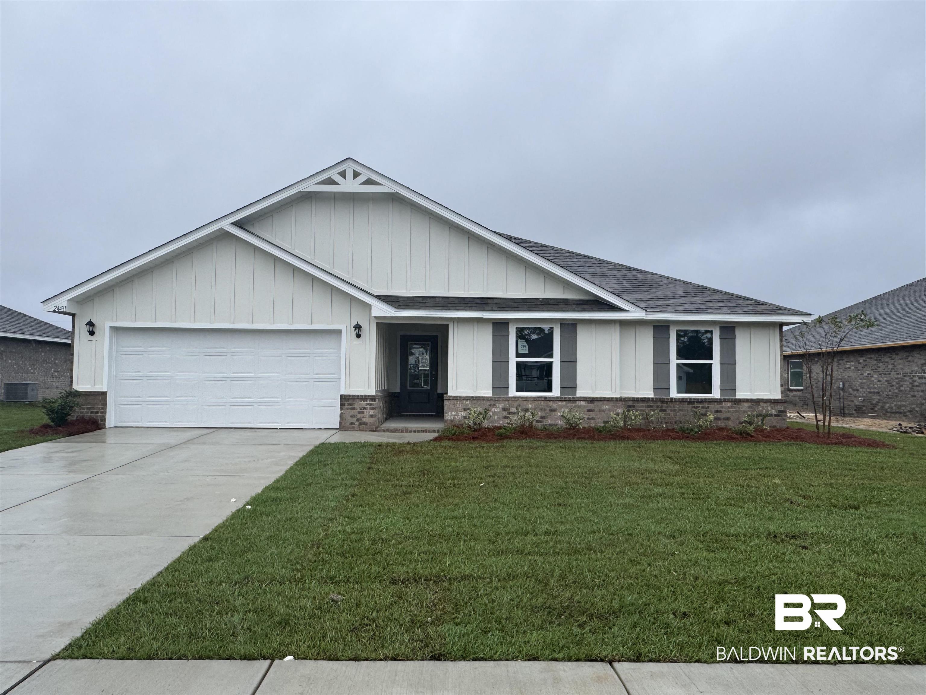 24431 Ringneck Loop Elberta, AL 36530 - Photo 2 of 15 View of front of house with a front lawn, a garage, and central AC
