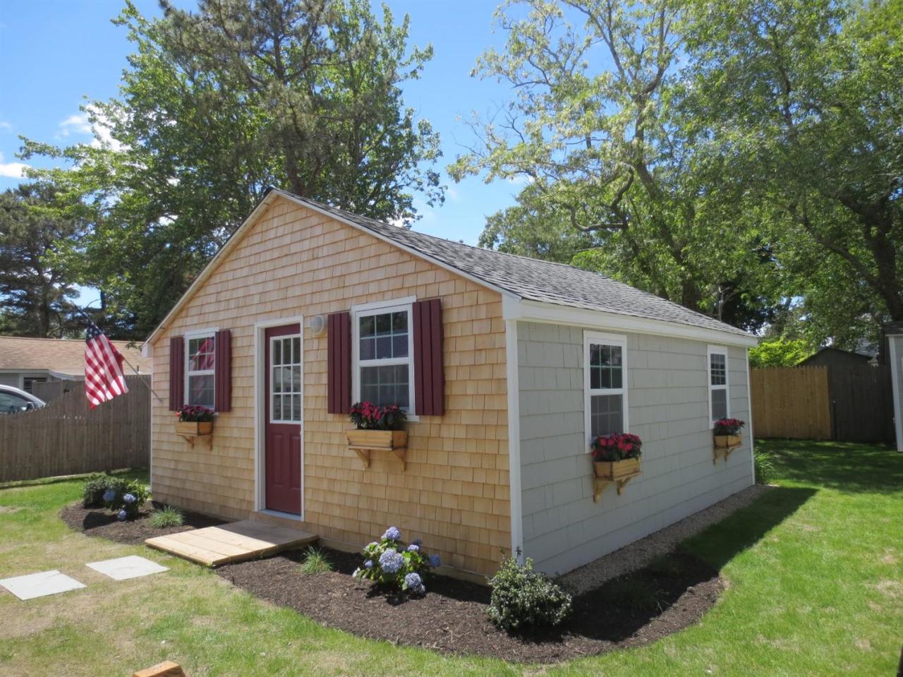 248 Old Wharf Road, Unit E2 Dennis Port, MA 02639 - Photo 1 of 27 a backyard of a house with seating space