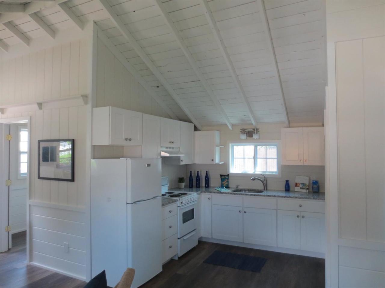 248 Old Wharf Road, Unit E2 Dennis Port, MA 02639 - Photo 12 of 27 a kitchen with white cabinets and white appliances