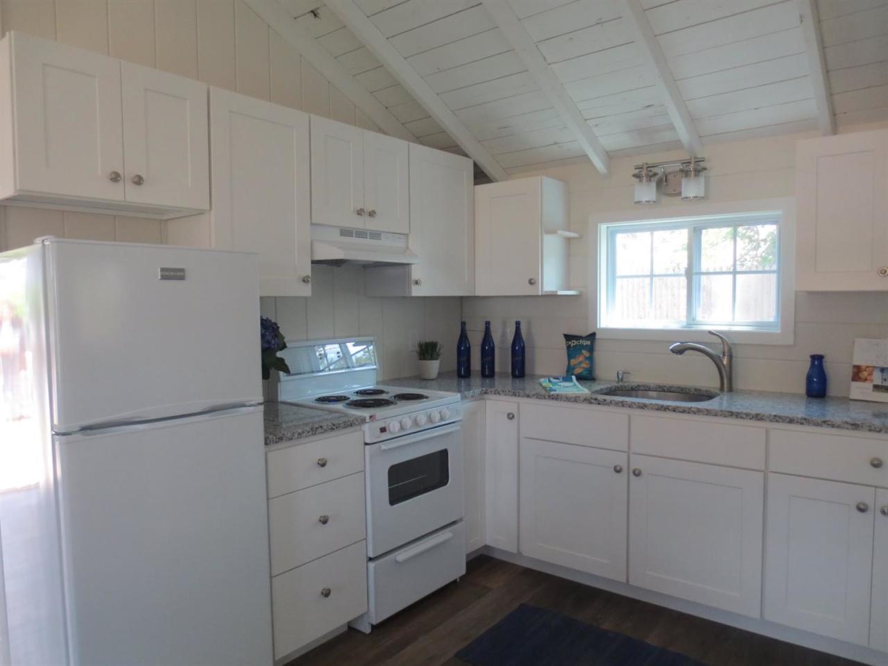 248 Old Wharf Road, Unit E2 Dennis Port, MA 02639 - Photo 14 of 27 a kitchen with cabinets appliances a sink and a window