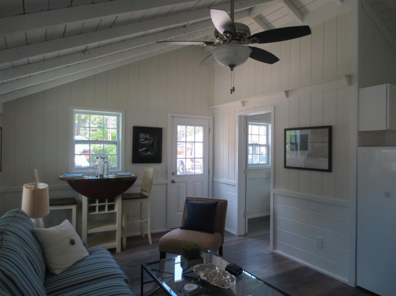 248 Old Wharf Road, Unit E2 Dennis Port, MA 02639 - Photo 16 of 27 a living room with furniture a window and a chandelier