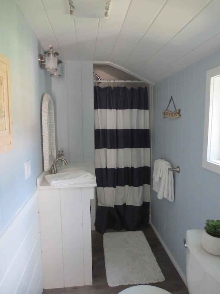 248 Old Wharf Road, Unit E2 Dennis Port, MA 02639 - Photo 17 of 27 a bathroom with a sink a toilet and shower