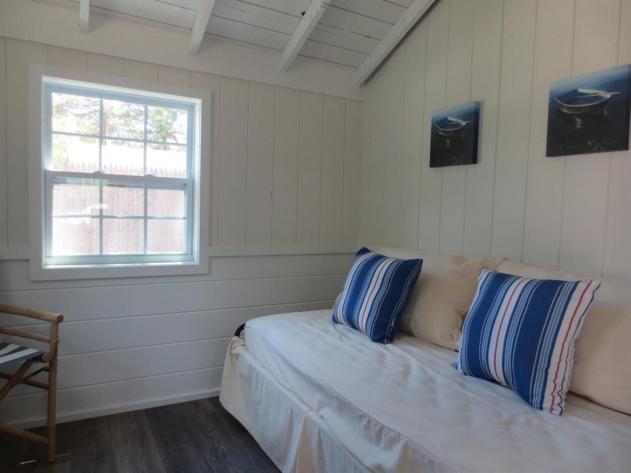 248 Old Wharf Road, Unit E2 Dennis Port, MA 02639 - Photo 18 of 27 a bedroom with bed and wooden floor