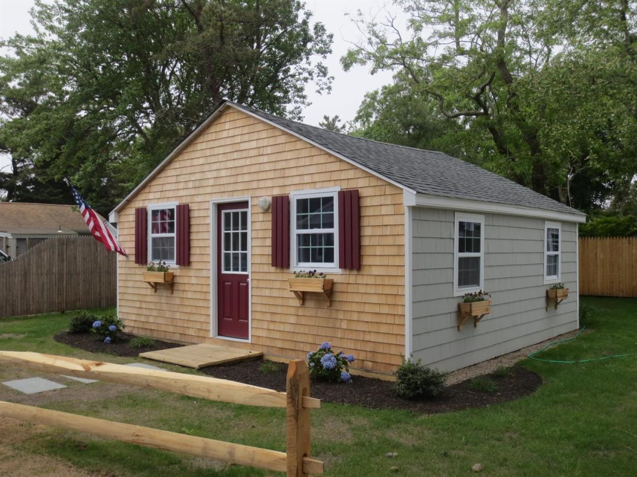 248 Old Wharf Road, Unit E2 Dennis Port, MA 02639 - Photo 20 of 27 a view of a house with a yard