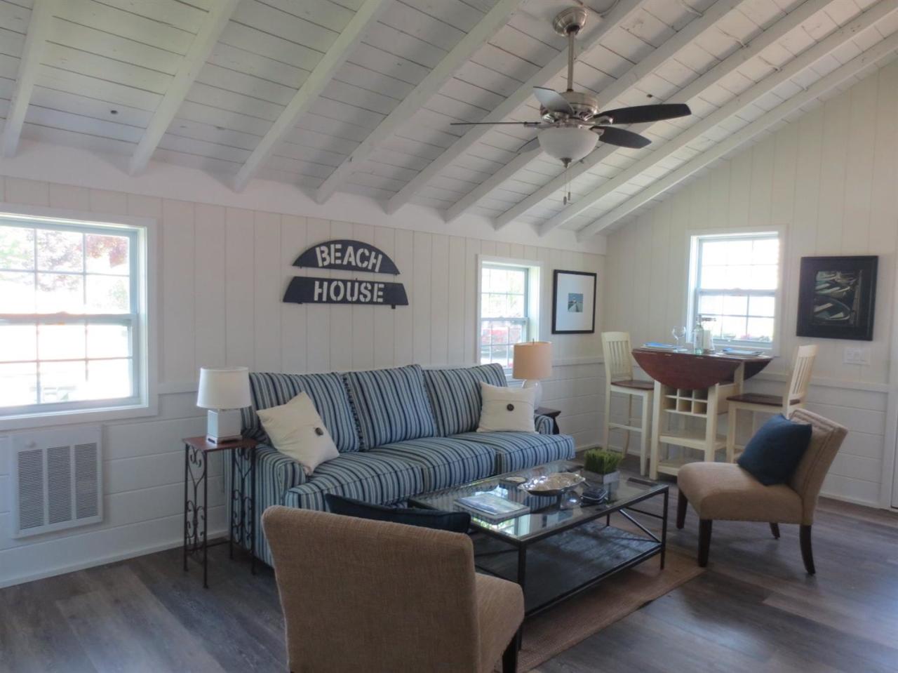 248 Old Wharf Road, Unit E2 Dennis Port, MA 02639 - Photo 2 of 27 a living room with furniture and a wooden floor