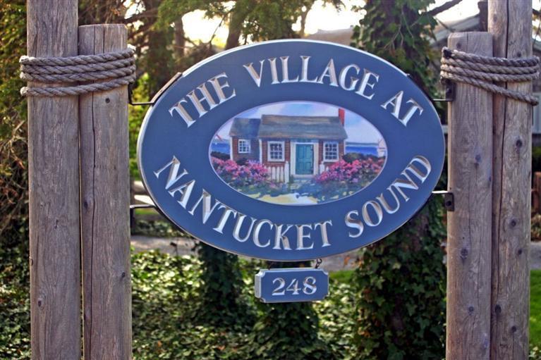 248 Old Wharf Road, Unit E2 Dennis Port, MA 02639 - Photo 3 of 27 a sign that is on top of a pole