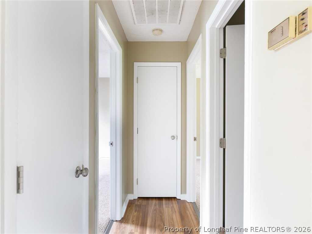 115 Eulon Loop, Unit A Raeford, NC 28376 - Photo 5 of 16 a view of a hallway with wooden floor and a bathroom