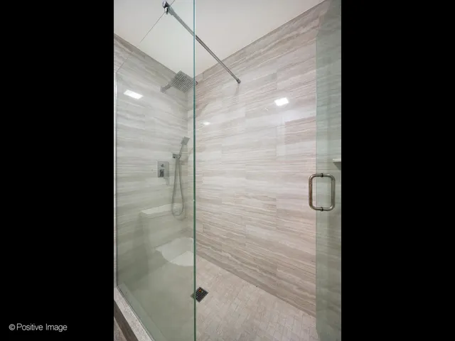a bathroom with a glass shower door