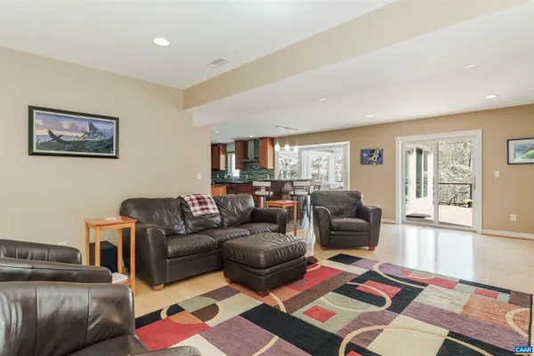 a living room with furniture and floor to ceiling windows