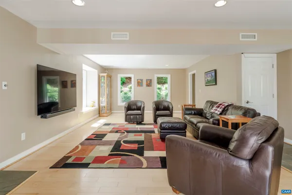 a living room with furniture and large windows