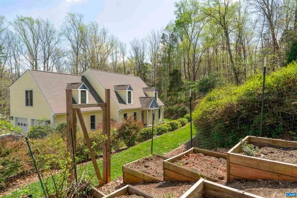aerial view of a house with yard and trees