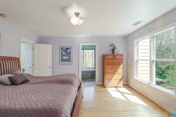 a bathroom with a granite countertop toilet a sink and a mirror