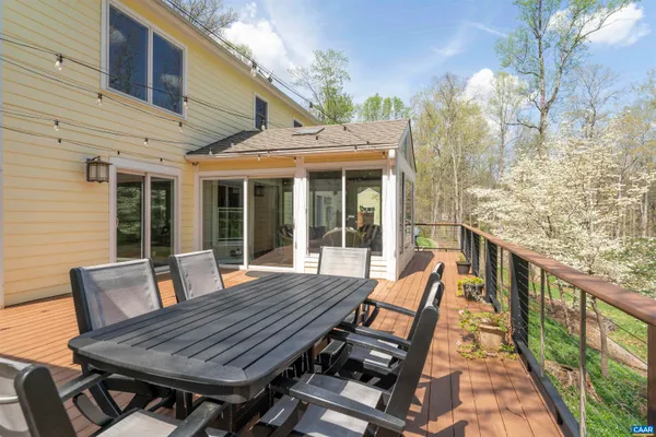 a view of chairs on the deck with wooden floor