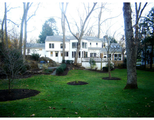60 Old Colony Road Wellesley, MA 02481 - Photo 1 of 1 a front view of a house with a garden and trees