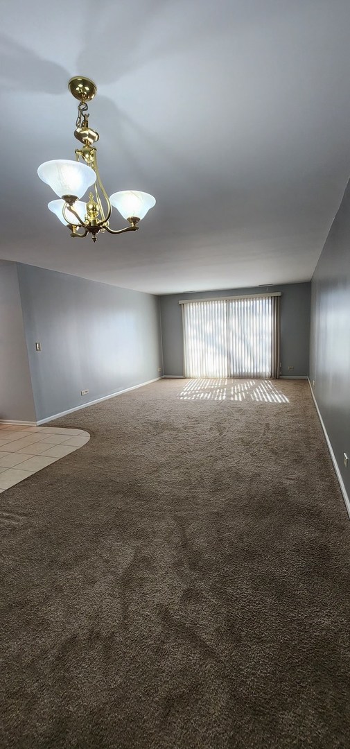 7730 Dempster Street, Unit 209 Morton Grove, IL 60053 - Photo 5 of 32 a view of an empty room with window