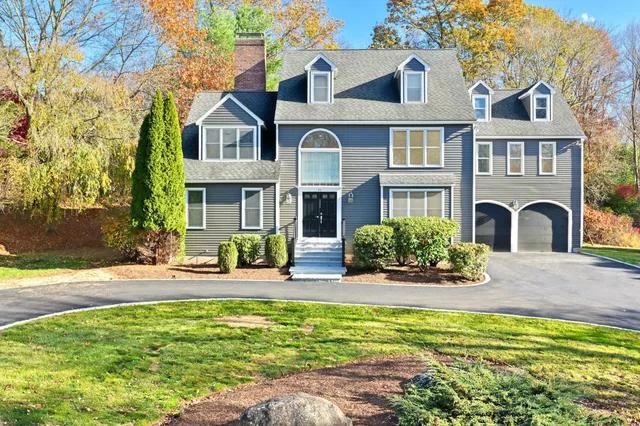 a front view of a house with swimming pool and porch
