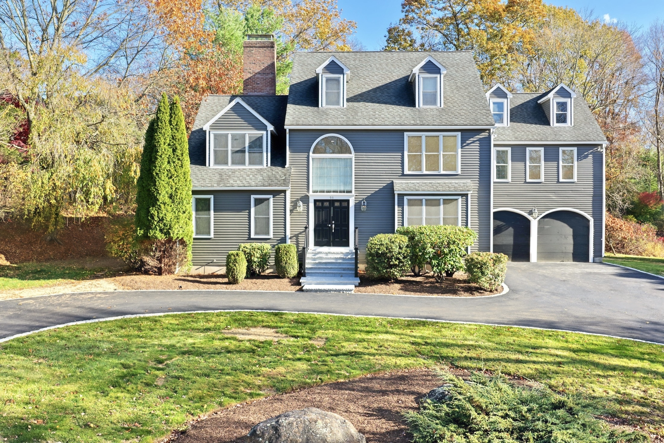 a front view of a house with swimming pool and porch