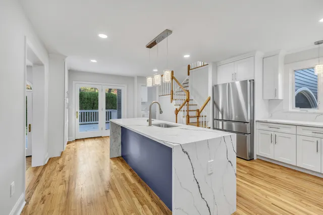a kitchen with a sink appliances and cabinets