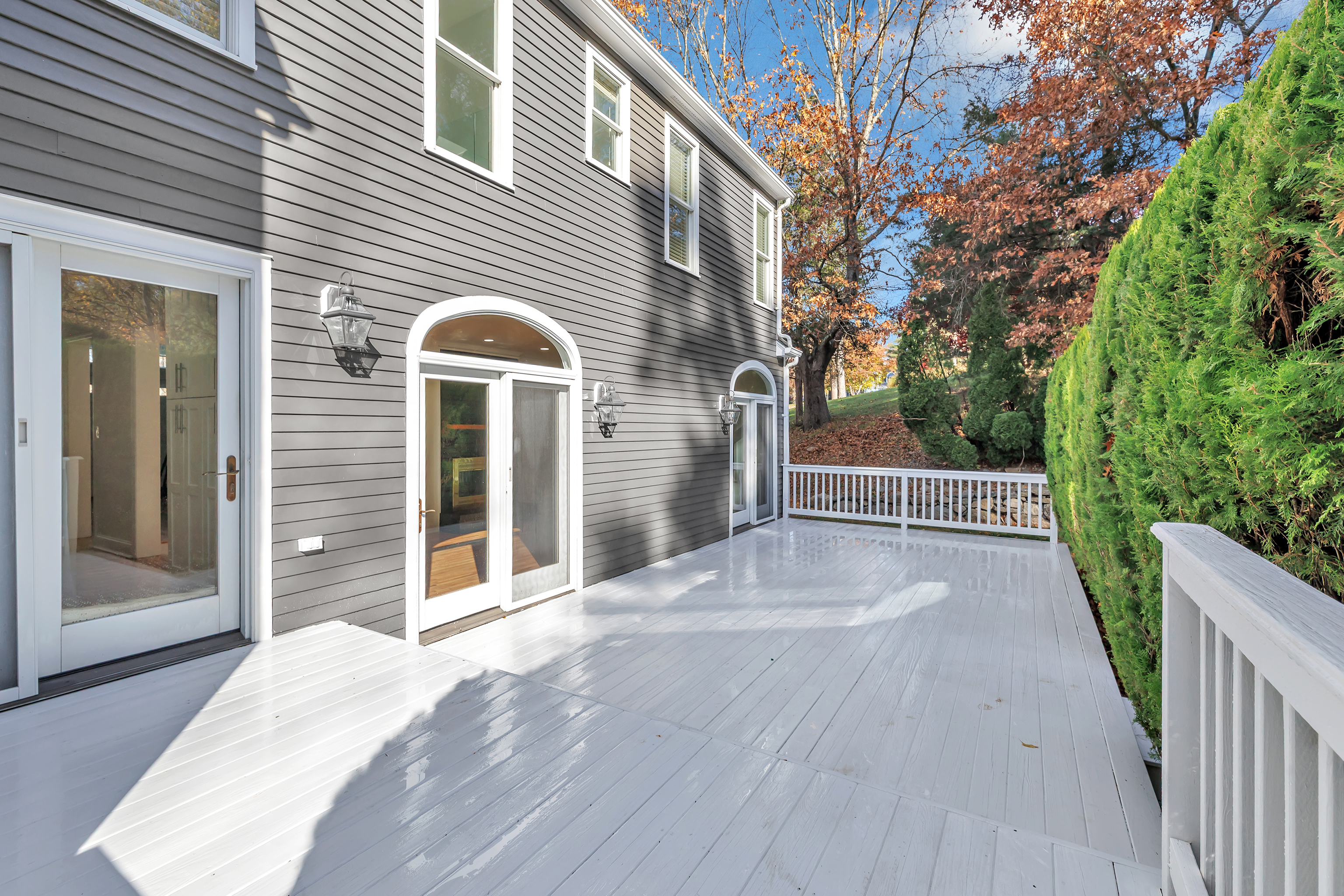 93 Putting Green Road North Trumbull, CT 06611 - Photo 13 of 40 a view of a brick house with a large window and wooden fence