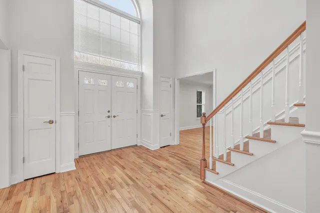 a view of entryway with wooden floor and stairs