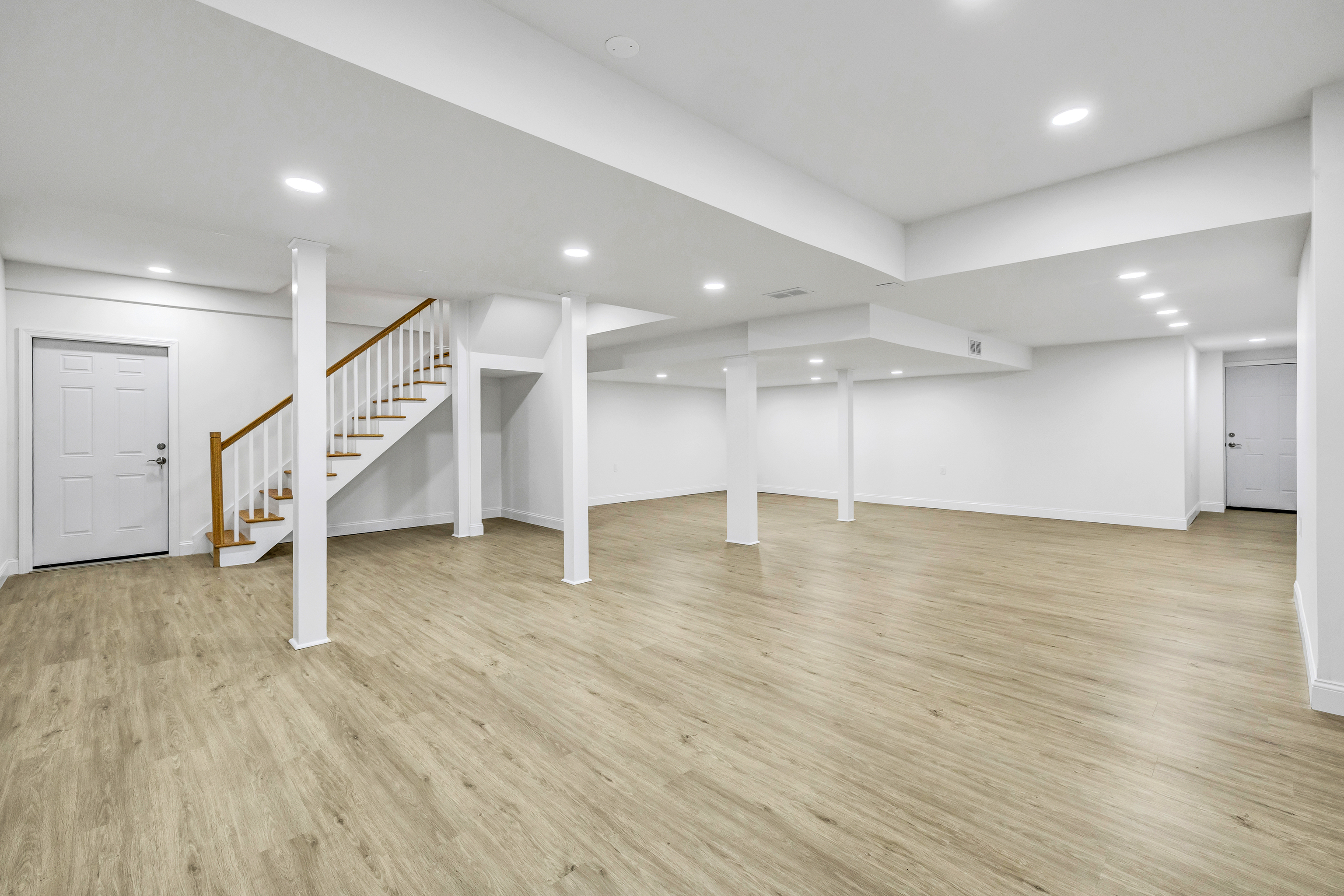 93 Putting Green Road North Trumbull, CT 06611 - Photo 35 of 40 an empty room with wooden floor and stairs