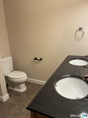 a bathroom with a toilet and a mirror