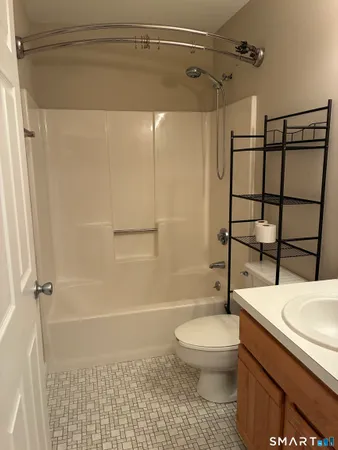 a bathroom with a toilet and shower