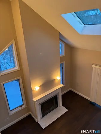 a view of an empty room and wooden floor