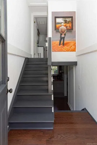 a view of entryway and hall with wooden floor