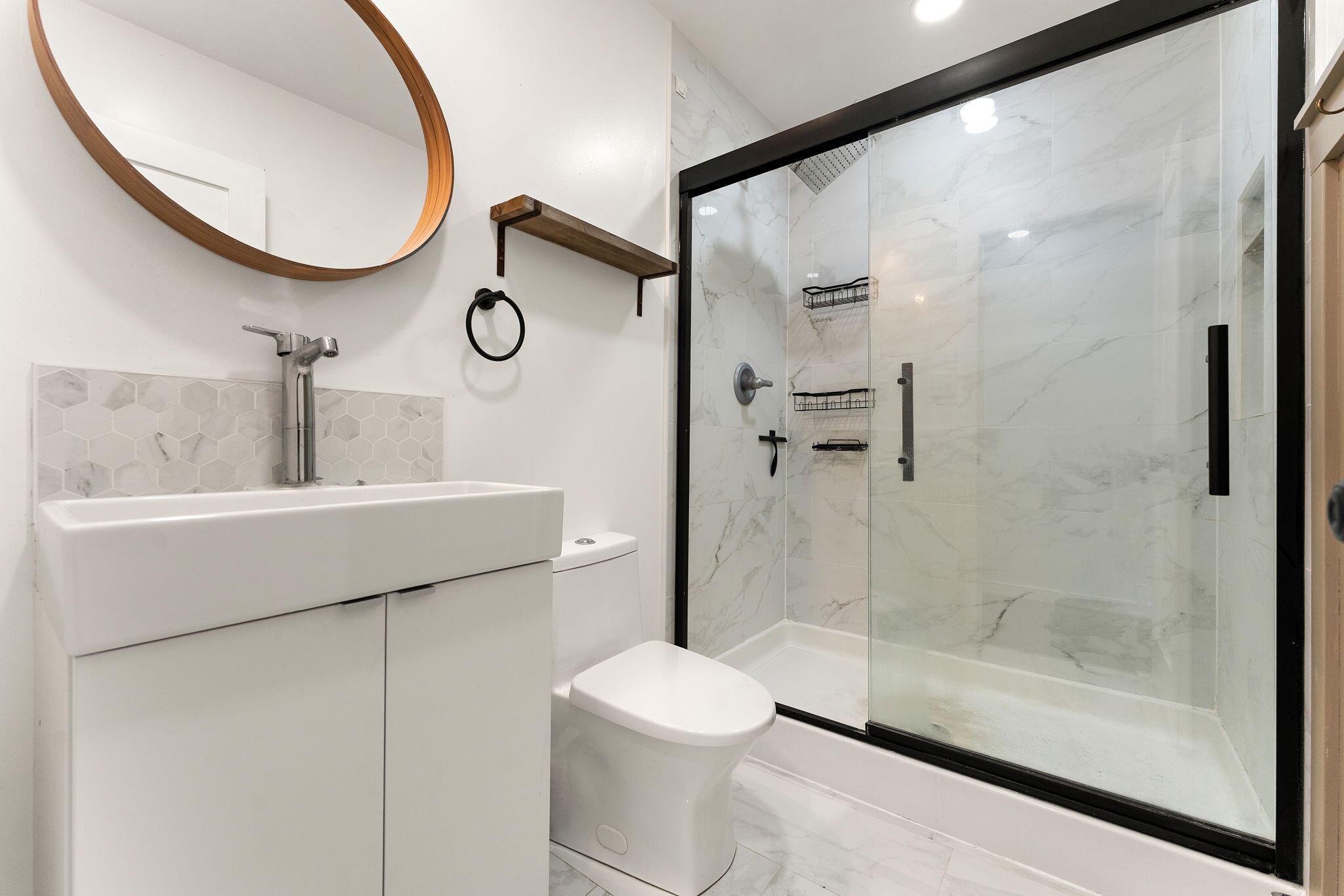 2840 Lois Street Portage, IN 46368 - Photo 11 of 22 a bathroom with a toilet a sink and a mirror