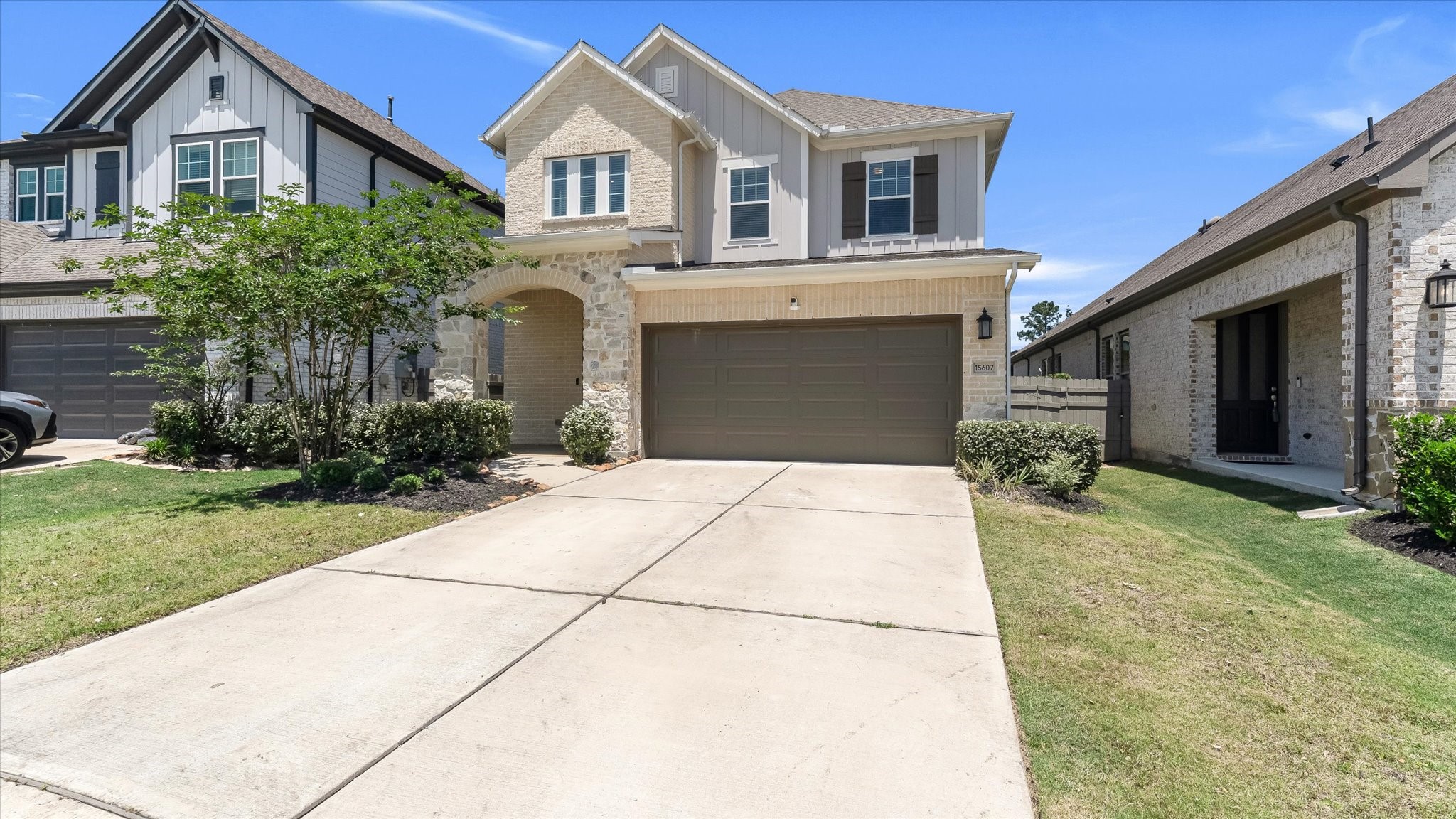 15607 Rising Wren Court Conroe, TX 77302 - Photo 2 of 40 a front view of a house with a garden