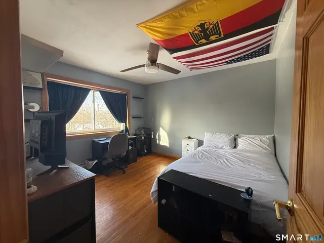 a bedroom with a bed and a window