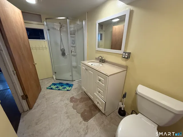 a bathroom with a sink toilet and shower