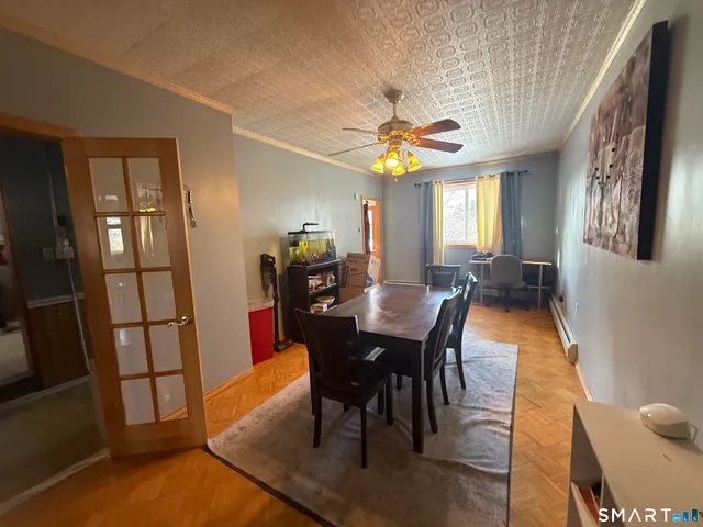 a view of a dining room with furniture and a chandelier