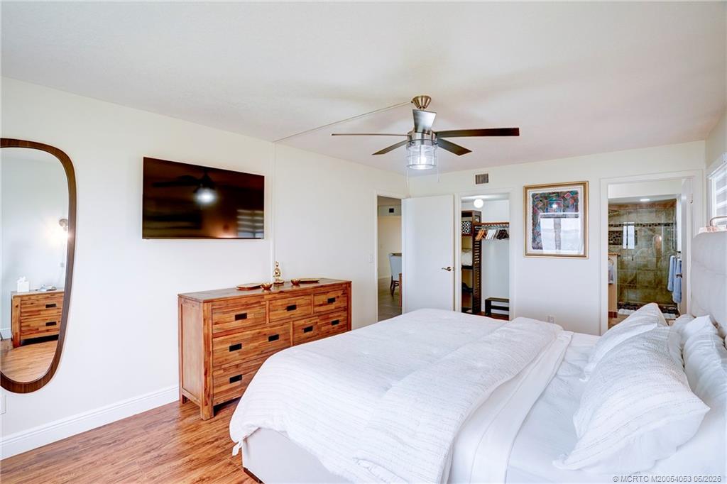 10 Northeast Plantation Road, Unit 101 Jensen Beach, FL 34957 - Photo 46 of 53 a bedroom with a bed and a flat screen tv