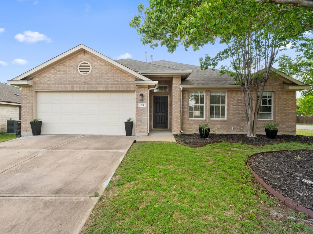 1201 Ridgewood Drive Leander, TX 78641 - Photo 1 of 29 Ranch-style house featuring brick siding, a garage, and concrete driveway
