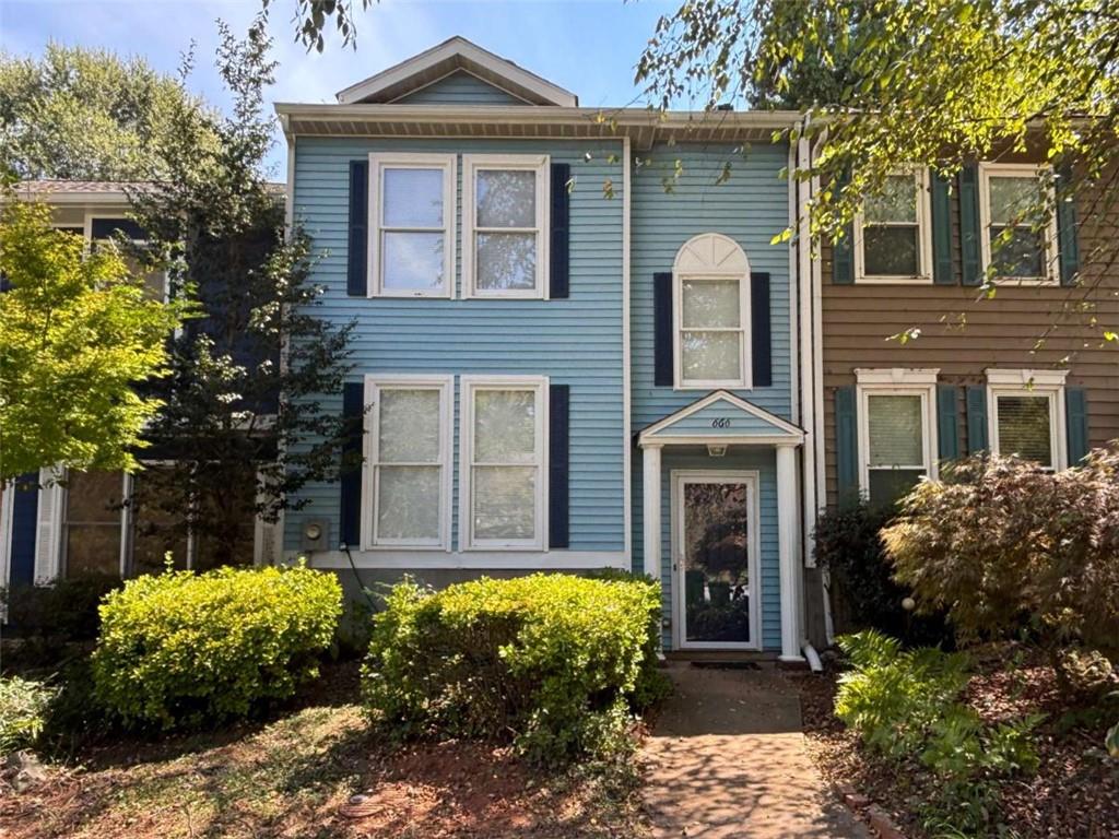 a front view of a house with garden