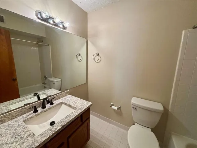a bathroom with a sink a toilet and mirror